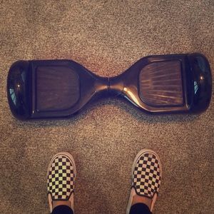A black hover board with lights and a charger